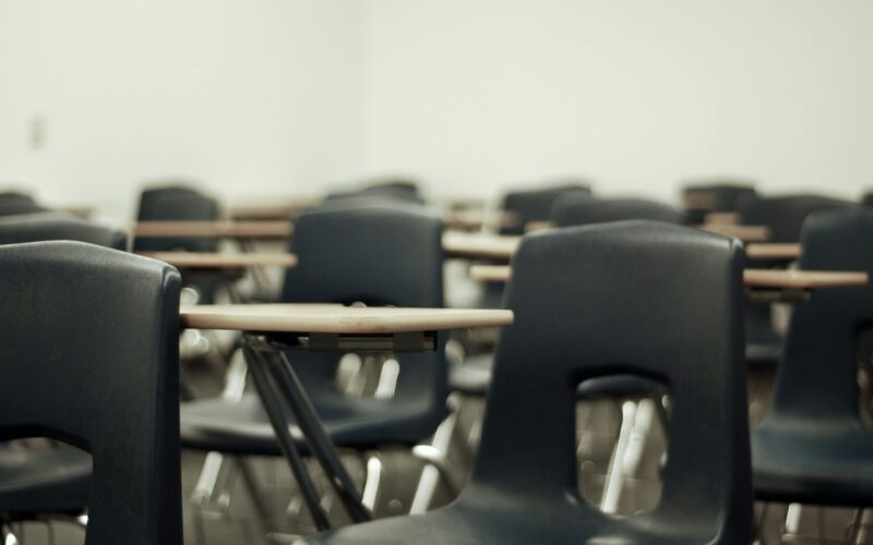 A photo of many chairs lined up in a room
