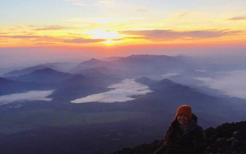 A photo of woman climbing mountain